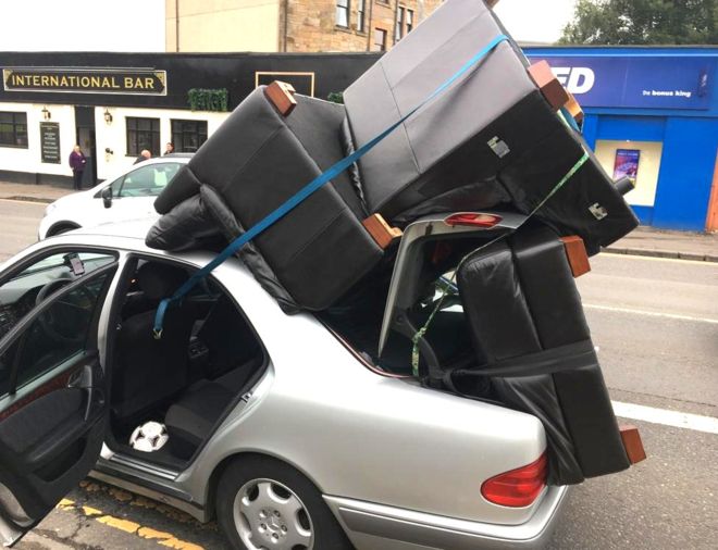 Car with chairs on top