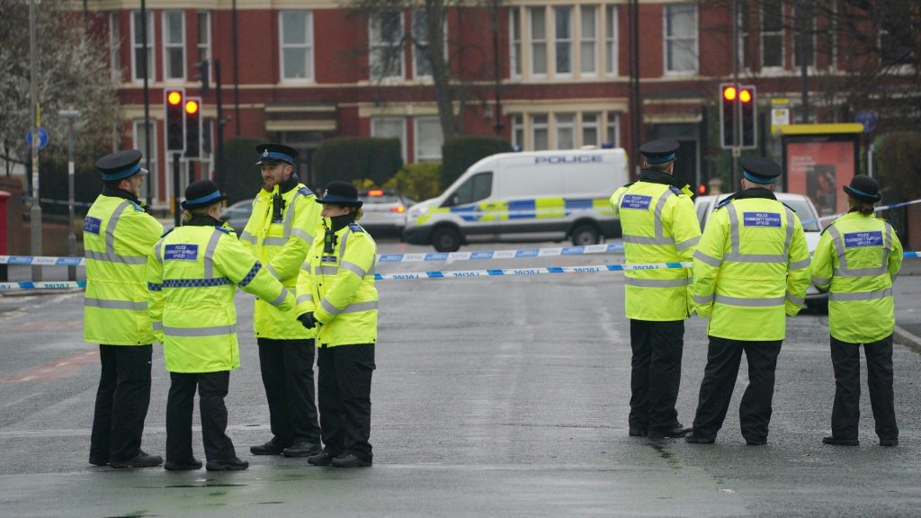 Image of police stood in road with Cordon